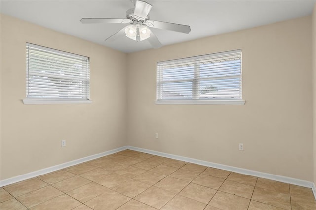 tiled spare room featuring ceiling fan and a wealth of natural light