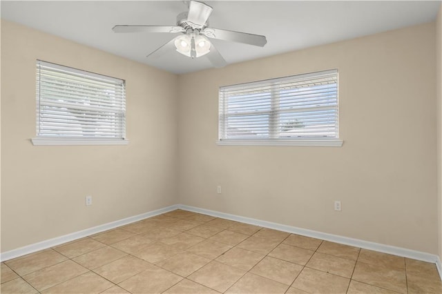 empty room featuring plenty of natural light, baseboards, and a ceiling fan