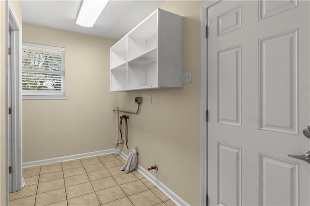 clothes washing area with hookup for a washing machine, light tile patterned floors, and gas dryer hookup