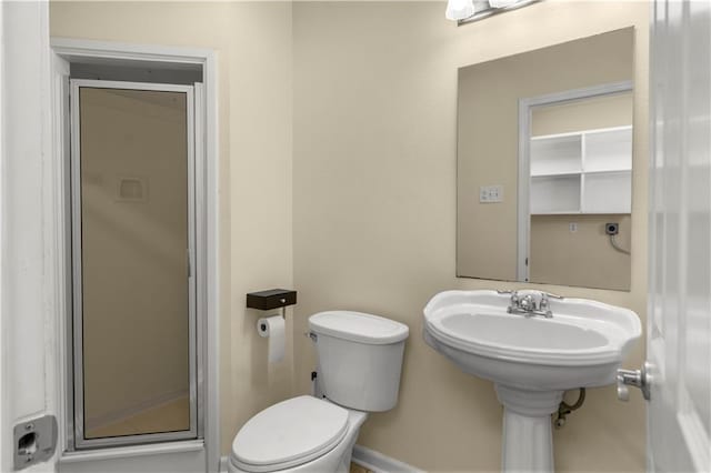 bathroom with toilet and an enclosed shower