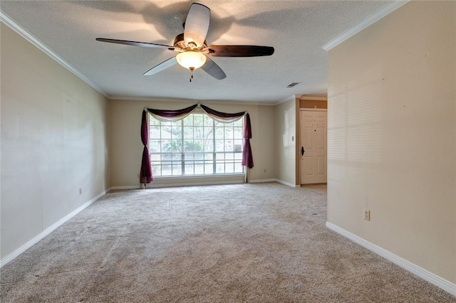 carpeted empty room featuring ornamental molding, a textured ceiling, and ceiling fan