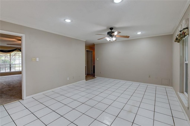 empty room with ceiling fan, light tile patterned floors, and ornamental molding