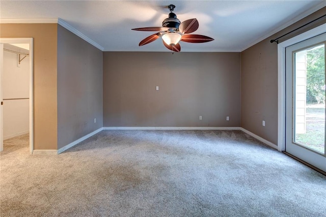 unfurnished room featuring crown molding, light carpet, and ceiling fan