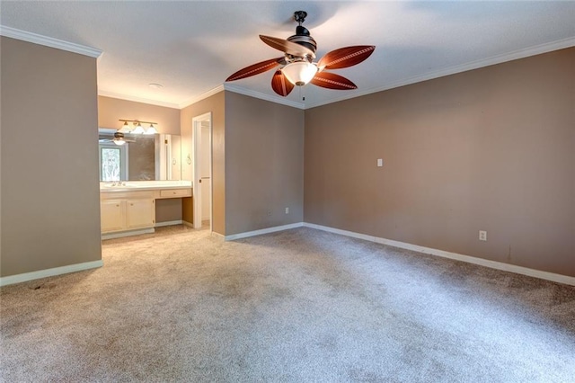 unfurnished bedroom with ceiling fan, ornamental molding, light carpet, and ensuite bathroom