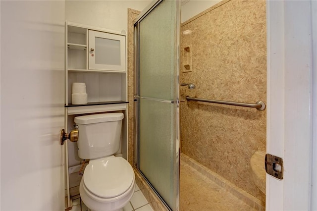 bathroom with a shower with shower door, toilet, and tile patterned floors