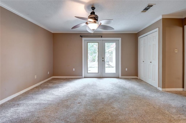 unfurnished bedroom featuring french doors, light colored carpet, access to exterior, ceiling fan, and a textured ceiling