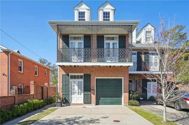 view of front of home with a balcony and a garage