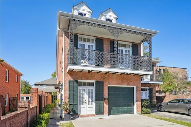 view of front of property with a balcony and a garage