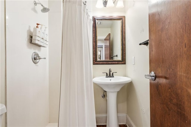 bathroom featuring curtained shower and sink