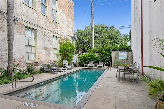 view of swimming pool with a patio