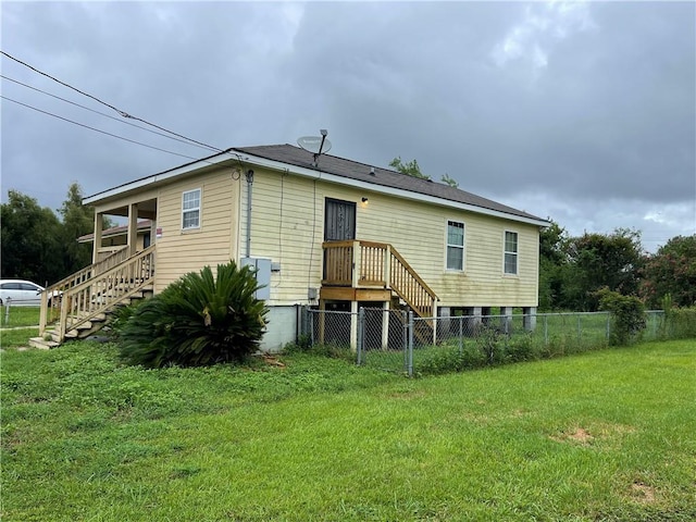 rear view of house with a yard