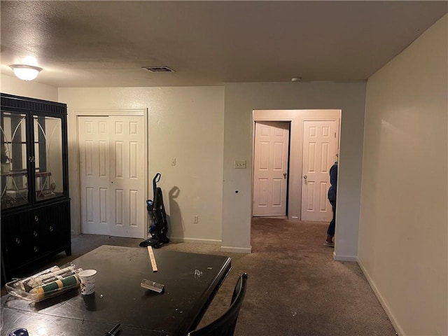 dining room with dark colored carpet