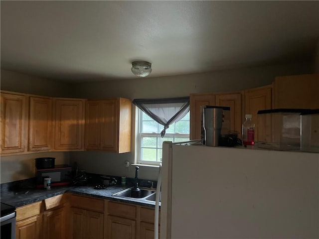 4653 Dale St, New Orleans, LA 70126 - kitchen featuring freestanding refrigerator and dark countertops
