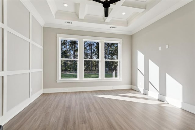 empty room with ornamental molding, light wood-type flooring, beam ceiling, coffered ceiling, and ceiling fan