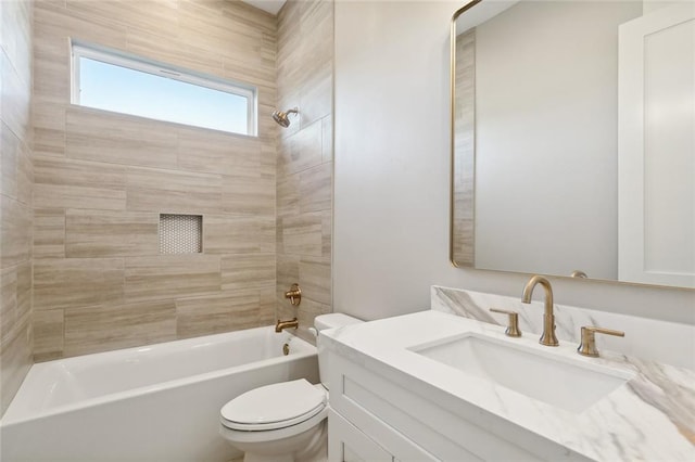 full bathroom featuring toilet, tiled shower / bath combo, and vanity