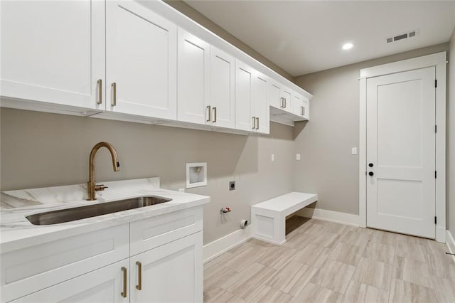 laundry area featuring hookup for an electric dryer, washer hookup, hookup for a gas dryer, cabinets, and sink