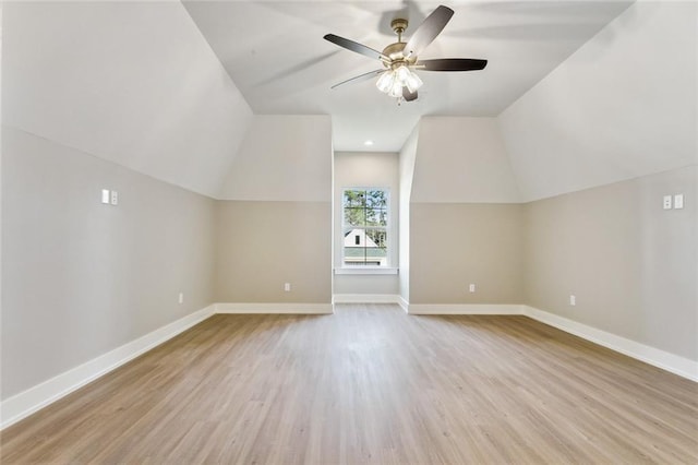 additional living space with light wood-type flooring, vaulted ceiling, and ceiling fan