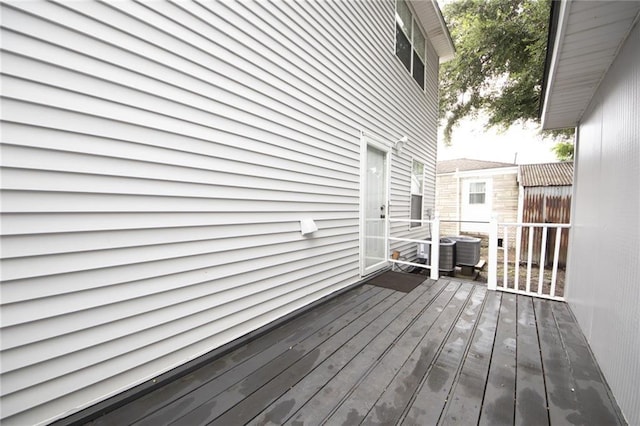 deck featuring a storage unit and central AC