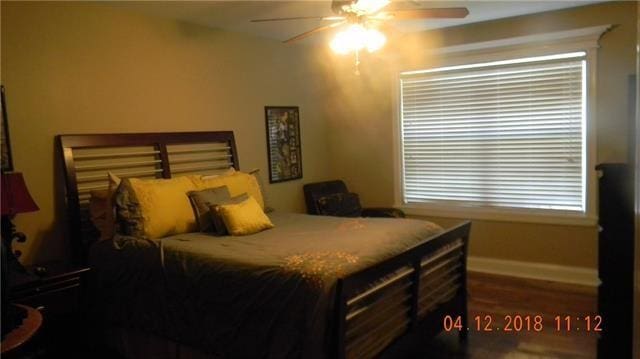 bedroom featuring ceiling fan and hardwood / wood-style flooring