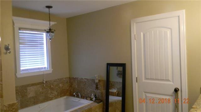 bathroom featuring a tub to relax in