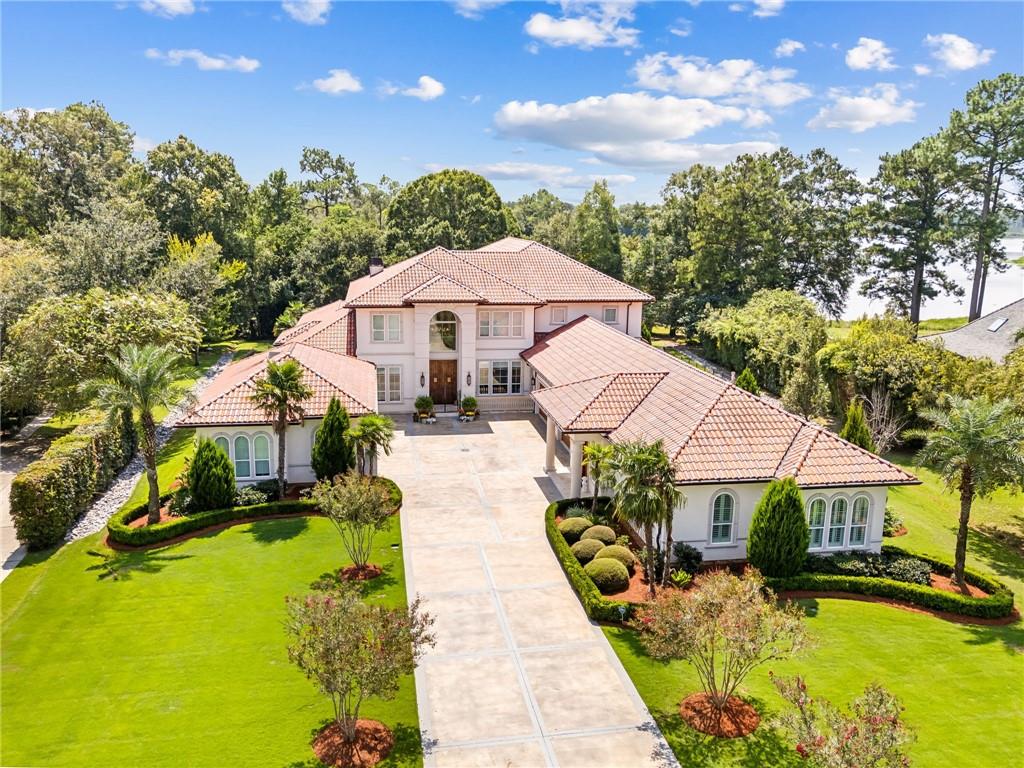 mediterranean / spanish house with a front lawn