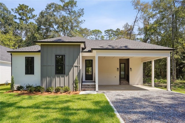 view of front of property with a carport and a front yard