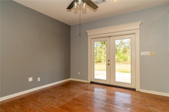 living room featuring ceiling fan, hardwood / wood-style flooring, and a raised ceiling