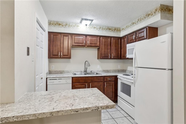 kitchen featuring a textured ceiling, sink, white appliances, and light tile patterned flooring