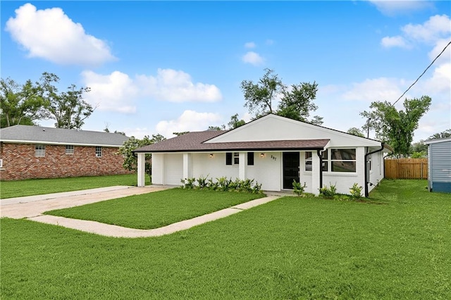 ranch-style home featuring a front lawn and a garage