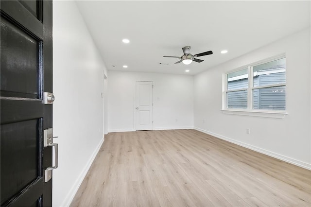 empty room featuring light hardwood / wood-style flooring and ceiling fan