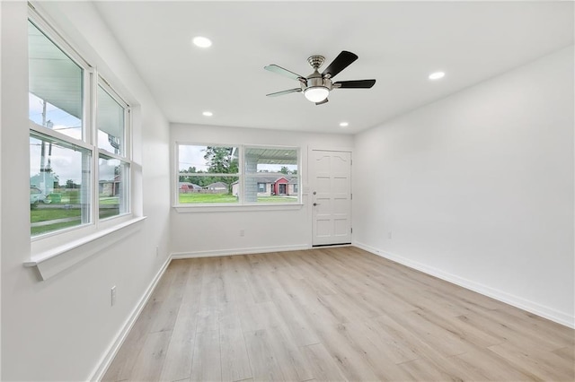 unfurnished bedroom featuring multiple windows, ceiling fan, and light hardwood / wood-style flooring