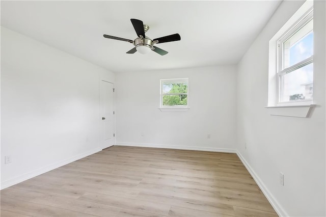 empty room with light hardwood / wood-style flooring and ceiling fan