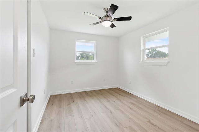 unfurnished room featuring a wealth of natural light, ceiling fan, and light hardwood / wood-style floors