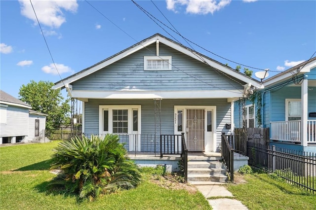 bungalow with a front lawn and covered porch