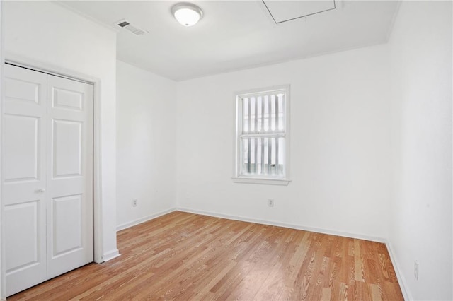 unfurnished bedroom with a closet and light hardwood / wood-style floors