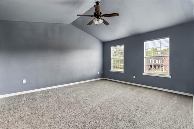 carpeted spare room featuring ceiling fan and lofted ceiling