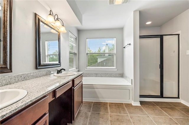 bathroom with tile patterned flooring, vanity, and independent shower and bath