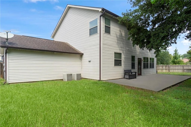 rear view of house with a patio area and a yard