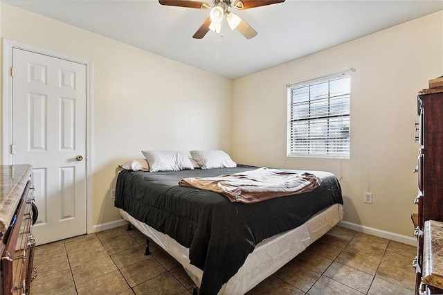 tiled bedroom featuring ceiling fan