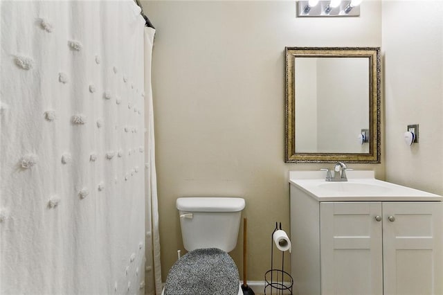 bathroom featuring a shower with shower curtain, vanity, and toilet