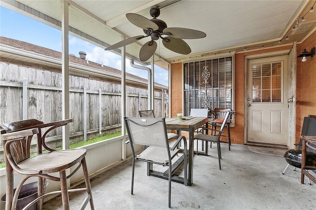 sunroom with ceiling fan and plenty of natural light