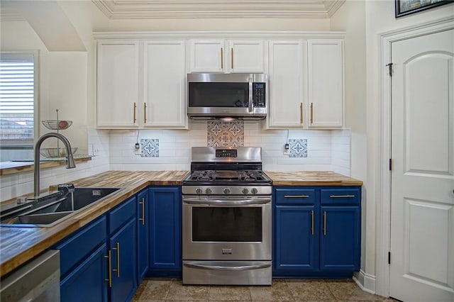 kitchen featuring white cabinetry, appliances with stainless steel finishes, butcher block counters, and sink