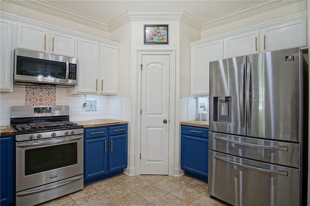 kitchen with blue cabinetry, stainless steel appliances, butcher block countertops, and white cabinets