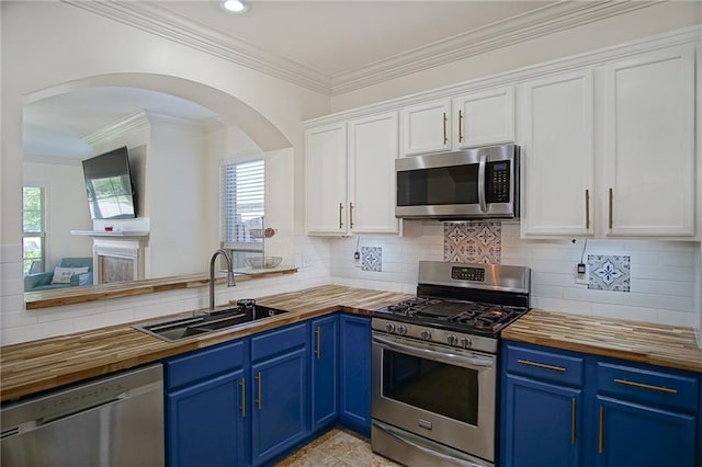 kitchen featuring white cabinetry, appliances with stainless steel finishes, blue cabinets, and sink