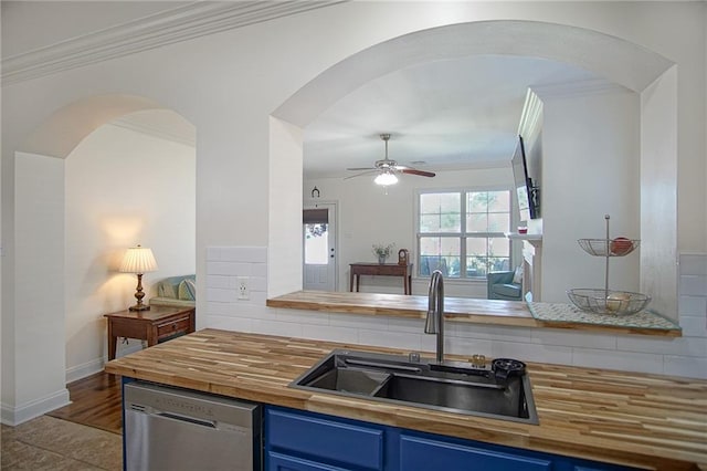 kitchen featuring blue cabinets, crown molding, sink, and stainless steel dishwasher