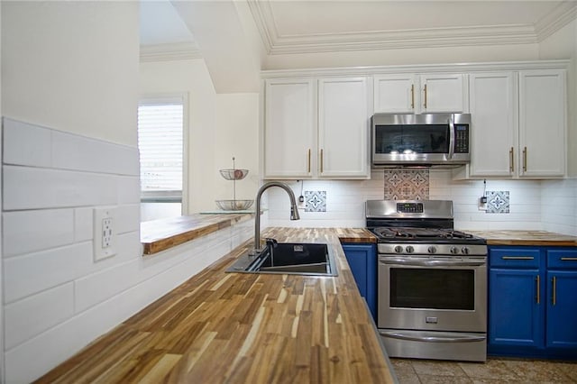 kitchen featuring blue cabinetry, sink, wooden counters, stainless steel appliances, and white cabinets