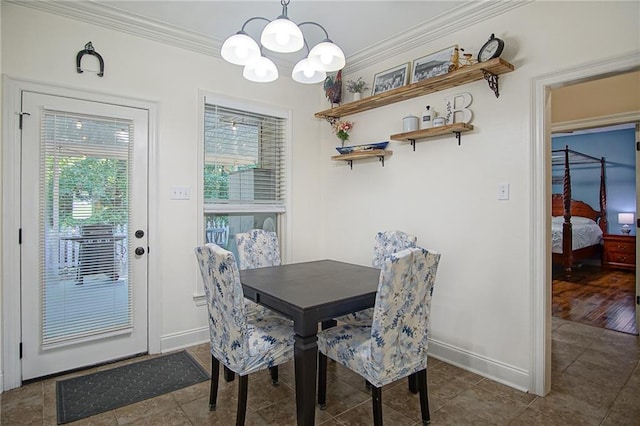 dining room featuring ornamental molding and an inviting chandelier