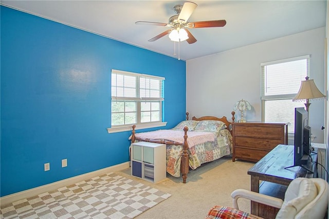 bedroom featuring light carpet and ceiling fan