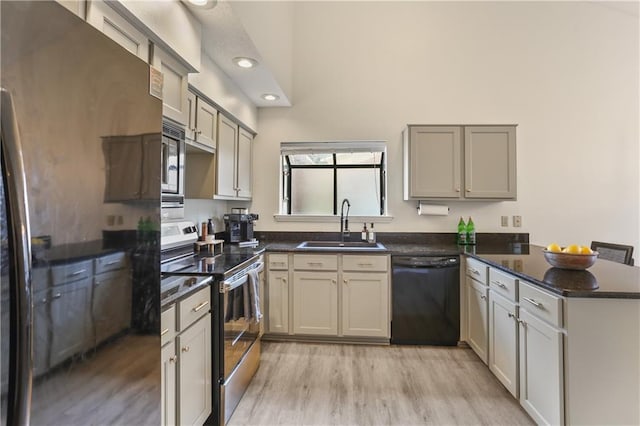 kitchen featuring gray cabinets, appliances with stainless steel finishes, kitchen peninsula, and sink