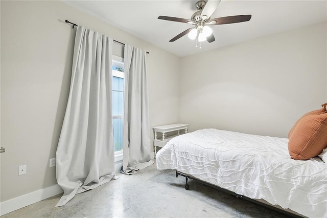 bedroom featuring ceiling fan and concrete flooring